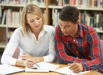 One-on-one tutor working with high school student on exam prep