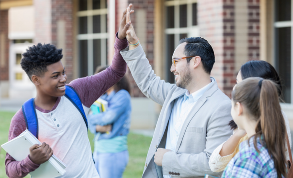 Tutor and student celebrating academic progress outside school